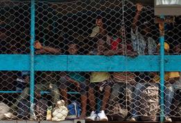 Local citizens try to flee this destroyed city by boat in Port-au-Prince, Haiti, Jan. 20, 2010. (Xinhua/David de la Pas)