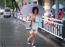 An undated photograph of a homeless man, nicknamed Brother Sharp for his good looks and sharp dress sense, wandering the streets of Ningbo, Zhejiang province, was recently posted on the Internet. He is one of the most talked about personalities in Chinese cyberspace today. [www.tianya.cn]