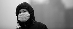 A pedestrian walks through a severe sandstorm that hits Beijing on Monday. 