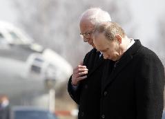 Russian Prime Minister Vladimir Putin (R) and Polish Ambasador in Moscow Jerzy Bahr pay their respects to Polish President Lech Kaczynski during a farewell ceremony at the airport of Smolensk April 11, 2010. Poles were in deep mourning on Sunday after President Lech Kaczynski and many of the country's ruling elite were killed in a plane crash. [Xinhua]