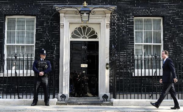 Britain's new Prime Minister David Cameron arrives at No. 10 Downing Street in London, Britain, May 13, 2010. The new British Prime Minister David Cameron held the first cabinet meeting of his Conservatives-Lib-Dem coalition goverment Thursday morning. [Xinhua]