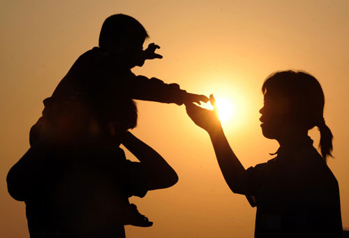 The couple entertain their 2-year-old boy after work in Hangzhou, East China's Zhejiang province, May 25, 2010.