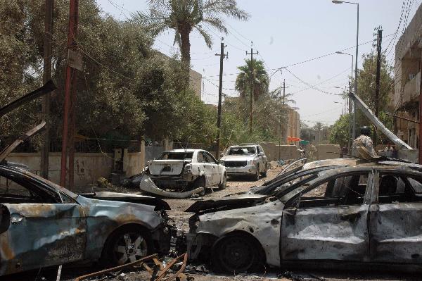 Vehicle debris are seen at blast site in Baghdad, capital of Iraq, June 20, 2010. At least 33 people were killed and 54 were wounded in two car bomb explosions in western Baghdad on Sunday. [Xinhua]