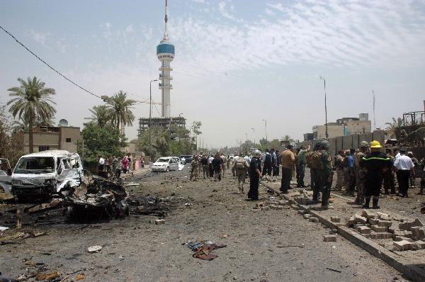 Rescuers and soldiers gather at blast site in Baghdad, capital of Iraq, June 20, 2010. At least 33 people were killed and 54 were wounded in two car bomb explosions in western Baghdad on Sunday. [Xinhua]