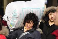 Passengers line up to get into the Shenyang North Railway Station, in Shenyang, capital of northeast China&apos;s Liaoning Province, Jan. 25, 2011. According to an estimate based on the sales of train tickets, the station will witness a travel peak from Jan. 31 to Feb. 1, as the eve of the Chinese Spring Festival falls on Feb. 3 this year, which by tradition Chinese people should spend at home with family memebers. [Xinhua]