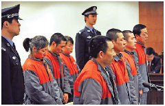 Seven child traffickers stand at Haidian district court on Wednesday. They each face sentences of five to 10 years.