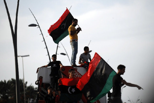 People in Tripoli, capital of Libya, show their jubilation as the news came that former leader Muammar Gaddafi has been killed in battle with NTC troops in Sirte. [Xinhua]