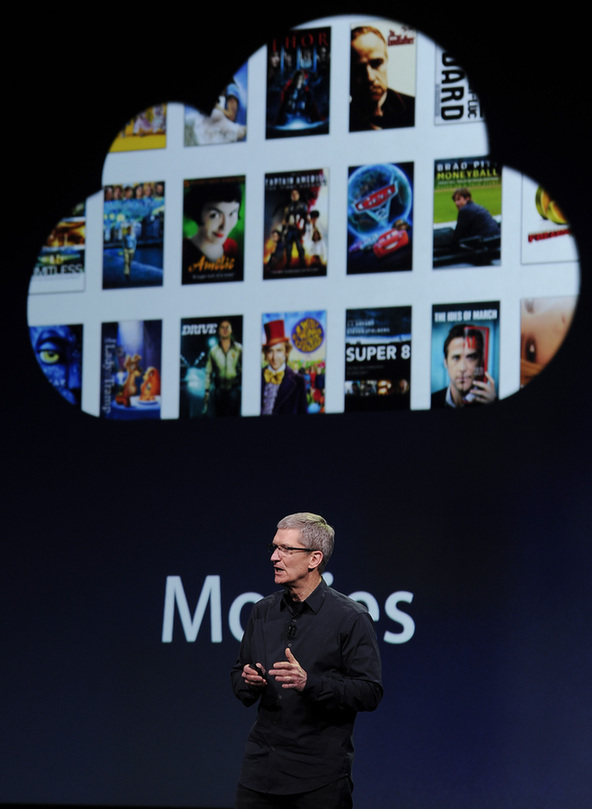 Apple CEO Tim Cook speaks during an Apple event as he introduces the new iPad as an image the device is projected on screen in San Francisco, California March 7, 2012. [Xinhua]