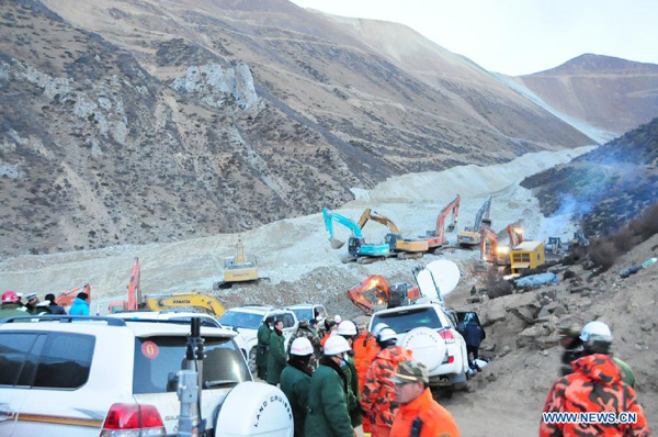 Rescuers work at the accident site after a major landslide hit a mining area of Tibet Huatailong Mining Development Co. Ltd, a subsidiary of the China National Gold Group Corporation, in Maizhokunggar County of Lhasa, capital of southwest China's Tibet Autonomous Region, March 30, 2013. A total of 83 workers were buried in the landslide, which happened on Friday morning. [Zhang Quan/Xinhua]