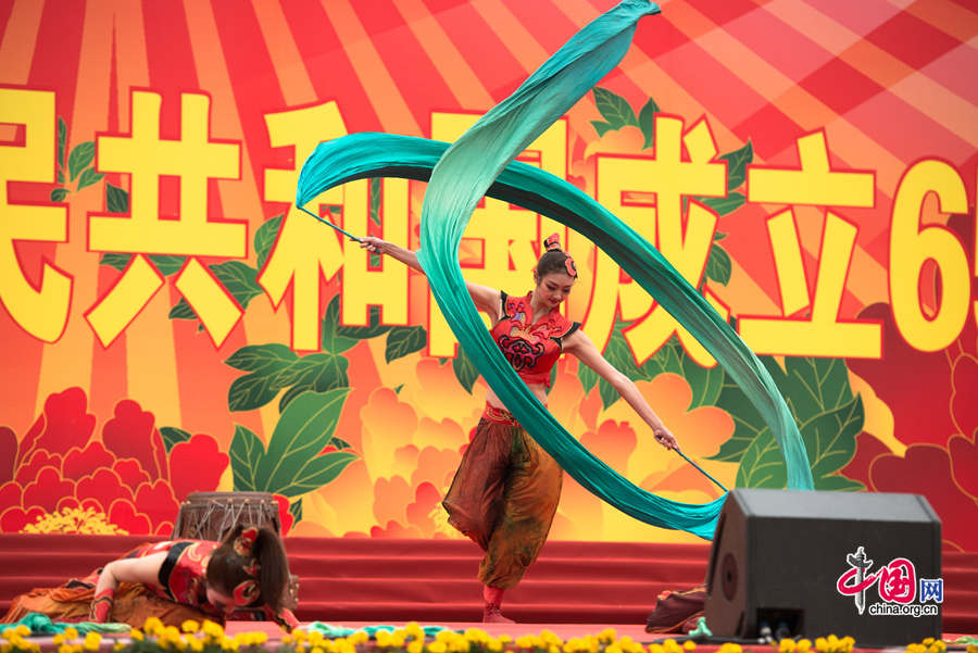 Chaoyang Park in the eastern downtown of Beijing, capital of China, stages grand commemorative activities on Wednesday, Oct. 1, 2014, to mark the 65th National Day holiday of the People&apos;s Republic of China, which was founded on Oct. 1, 1949. The celebrations at Chaoyang Park are in sync with similar activities in all of the around 300 parks in Beijing on this day. [Photo by Chen Boyuan / China.org.cn]