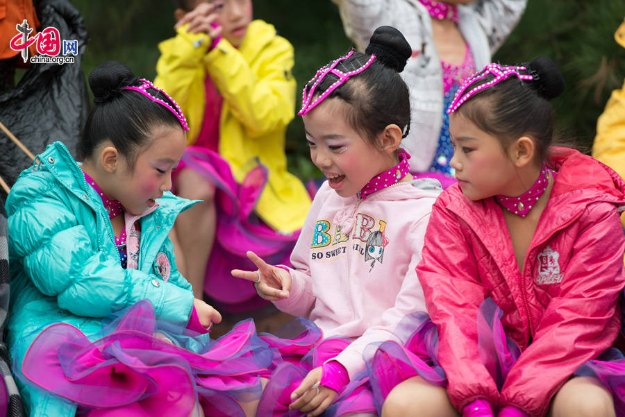 Chaoyang Park in the eastern downtown of Beijing, capital of China, stages grand commemorative activities on Wednesday, Oct. 1, 2014, to mark the 65th National Day holiday of the People&apos;s Republic of China, which was founded on Oct. 1, 1949. The celebrations at Chaoyang Park are in sync with similar activities in all of the around 300 parks in Beijing on this day. [Photo by Chen Boyuan / China.org.cn]