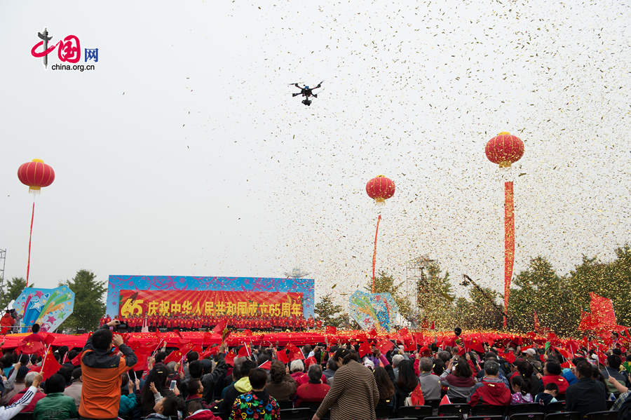 Chaoyang Park in the eastern downtown of Beijing, capital of China, stages grand commemorative activities on Wednesday, Oct. 1, 2014, to mark the 65th National Day holiday of the People&apos;s Republic of China, which was founded on Oct. 1, 1949. The celebrations at Chaoyang Park are in sync with similar activities in all of the around 300 parks in Beijing on this day. [Photo by Chen Boyuan / China.org.cn]