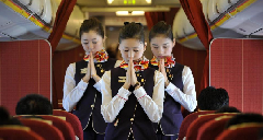 Hainan Airline: Airline hostesses mourn for the quake victims in Yushu prefecture of China’s Northwest Qinghai province on airplane, April 21, 2010.